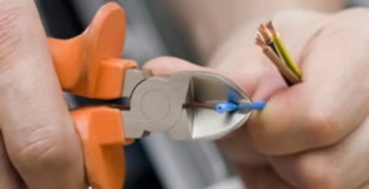 professional electrical services showing precise wire cutting by licensed electricians in Modesto, CA